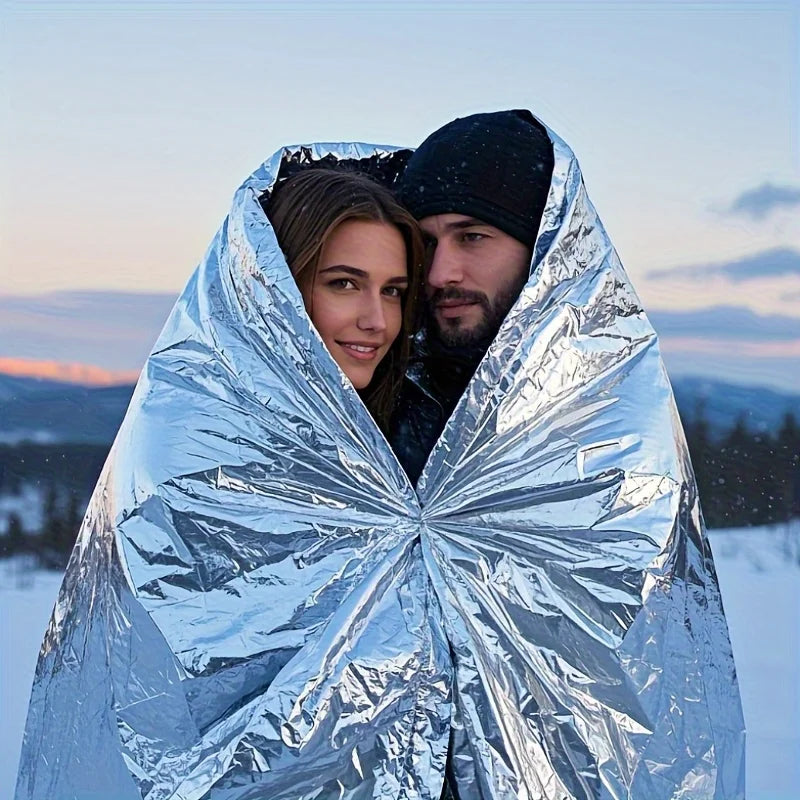 Outdoor emergency silver survival blanket with lightweight aluminum foil insulation suitable for camping hiking, and evacuation